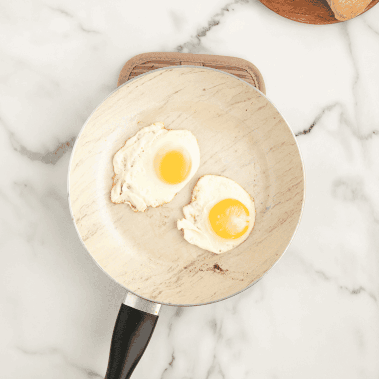 Place eggs in a frying pan, until cooked fully.