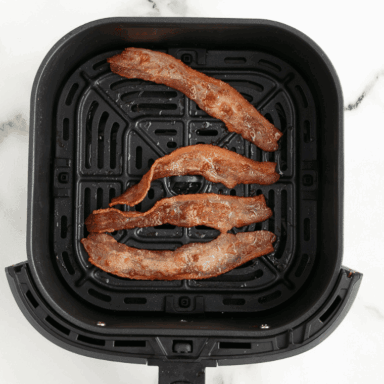Place bacon into the air fryer basket and cook until crispy.
