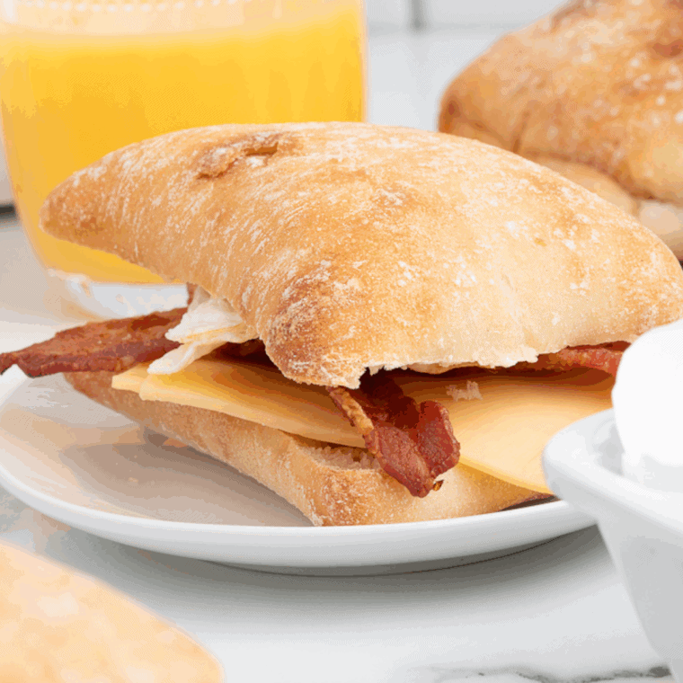Toasted ciabatta sandwich filled with egg, bacon, and melted gouda cheese, Starbucks-style.