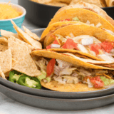 Recreate the Taco Bell Double Decker Taco at home with this easy copycat recipe! A crunchy taco shell wrapped in a soft tortilla with refried beans, seasoned beef, and all your favorite toppings.