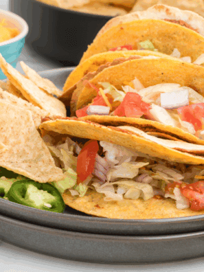 Recreate the Taco Bell Double Decker Taco at home with this easy copycat recipe! A crunchy taco shell wrapped in a soft tortilla with refried beans, seasoned beef, and all your favorite toppings.