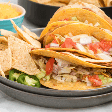 Recreate the Taco Bell Double Decker Taco at home with this easy copycat recipe! A crunchy taco shell wrapped in a soft tortilla with refried beans, seasoned beef, and all your favorite toppings.