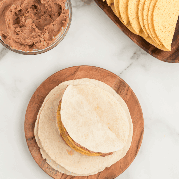 Add the tortilla with he meat over the other tortilla.