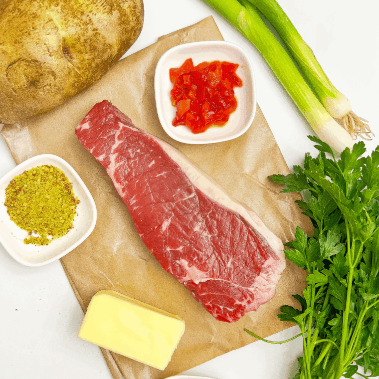 Ingredients needed for Cowboy Butter Steak and Potatoes on kitchen table.
