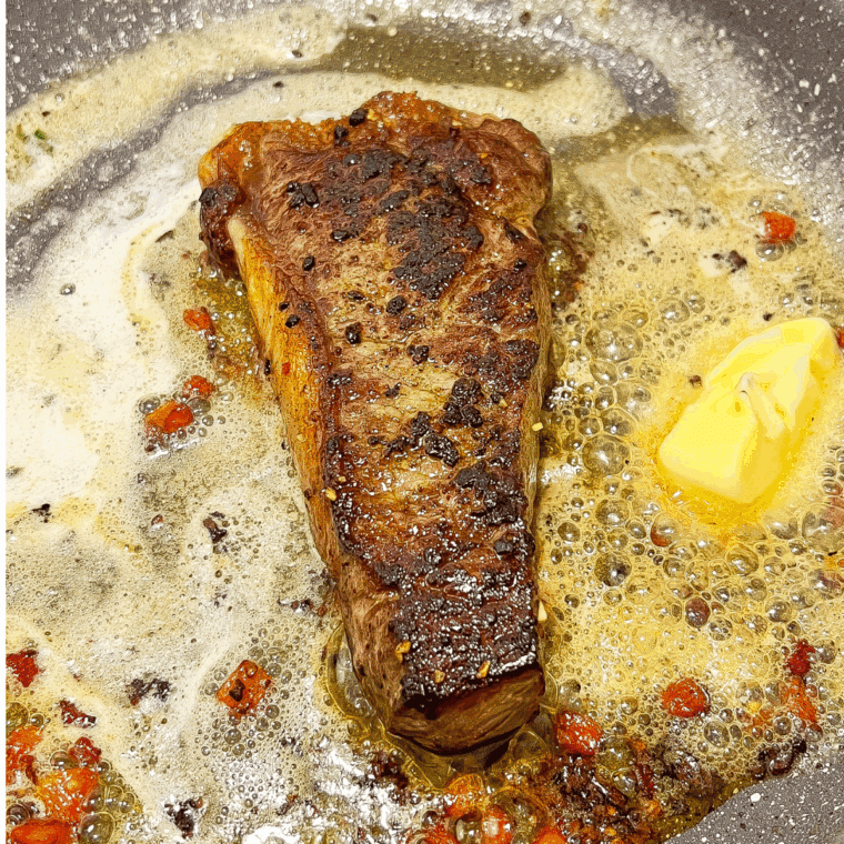 Resting cooked steak on a plate while leaving pan drippings for cooking potatoes.