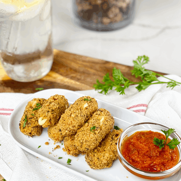 Golden-brown mozzarella sticks with crispy coating and gooey cheese inside.