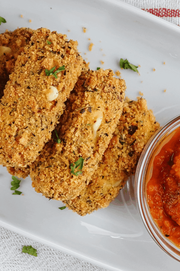 Crispy homemade Arby’s mozzarella sticks served with marinara sauce.