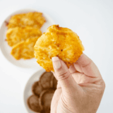 Golden, crispy Arby’s-style potato cakes stacked on a serving plate.