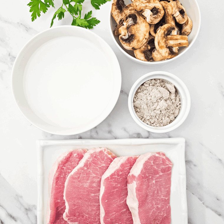 Ingredients needed for Crockpot Brown Gravy Smothered Pork Chops on kitchen table.