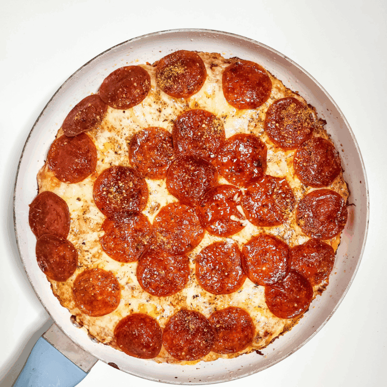 Ball of freshly made Domino’s style pizza dough resting on a floured surface, ready to be rolled out and baked.