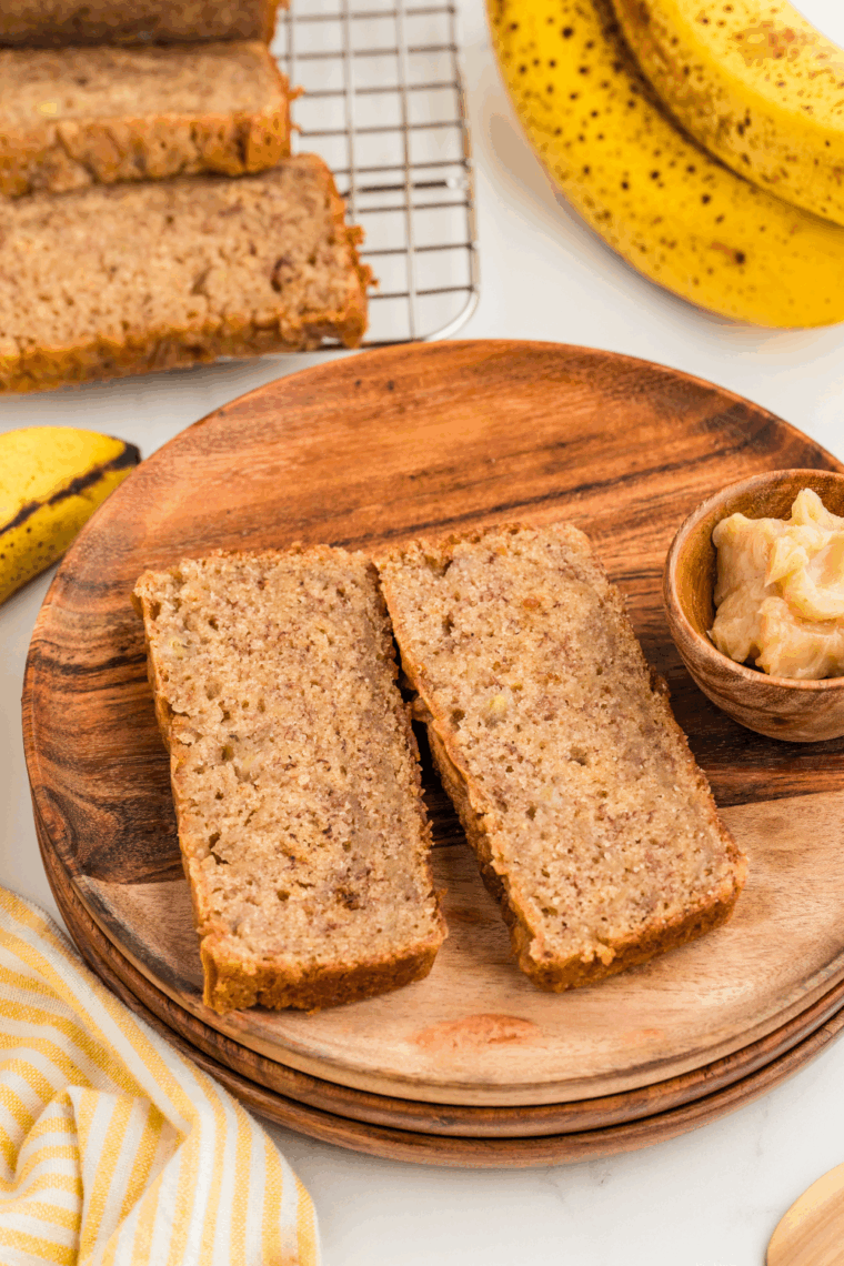 Freshly baked Golden Corral-style banana nut bread sliced on a wooden cutting board.