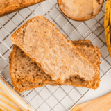 Sliced homemade banana nut bread on a wooden board, Golden Corral style.