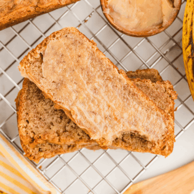 Sliced homemade banana nut bread on a wooden board, Golden Corral style.