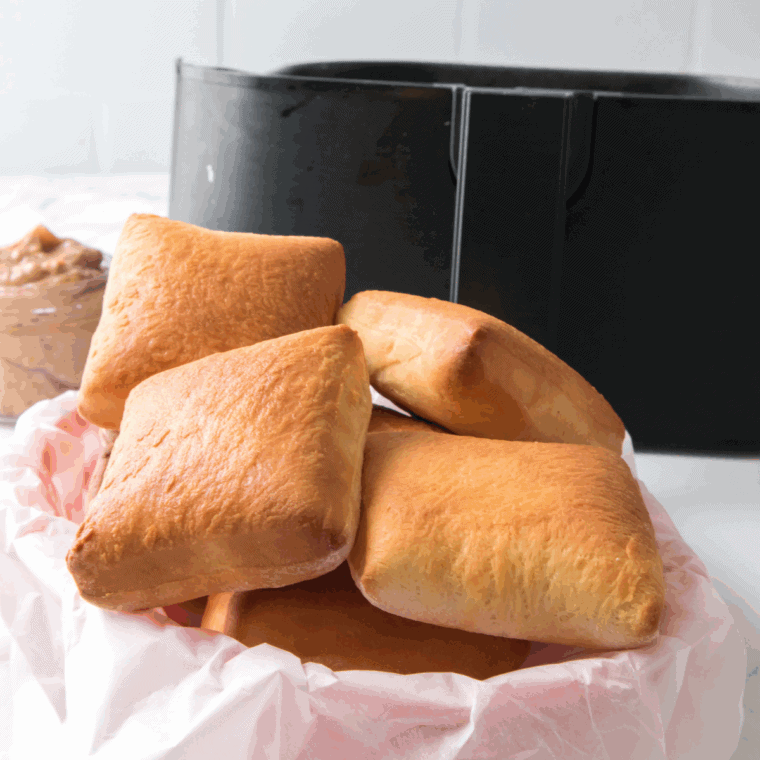 Freshly baked Golden Corral yeast rolls brushed with melted butter on a tray