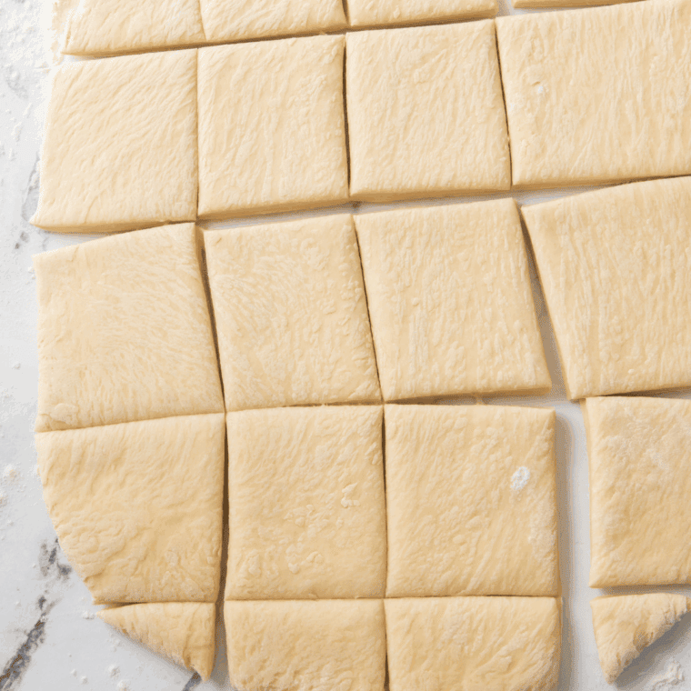 Using a sharp knife or pizza cutter, cut the dough into equal portions.