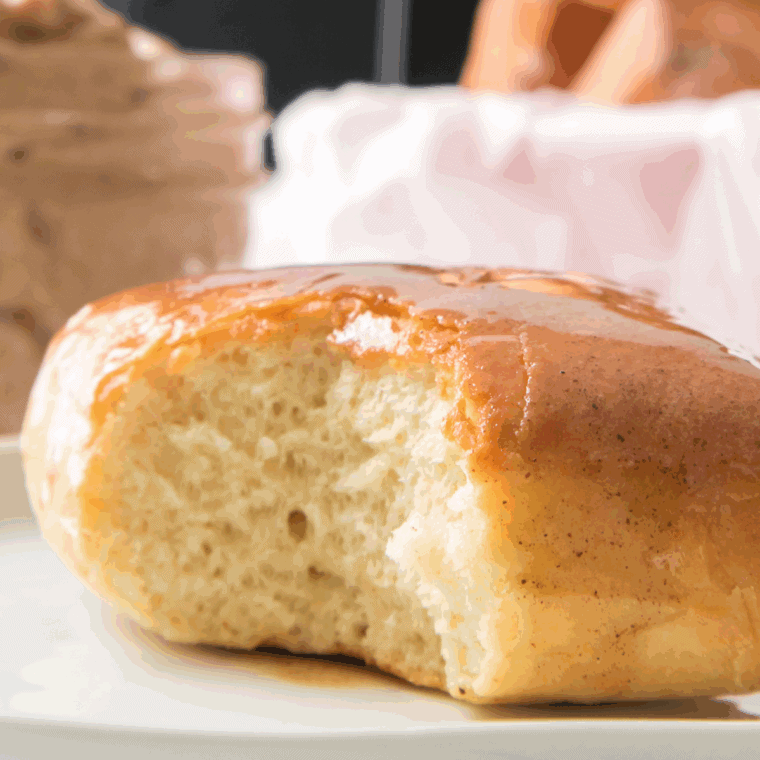 Golden Corral-style yeast rolls in air fryer basket, brushed with melted butter