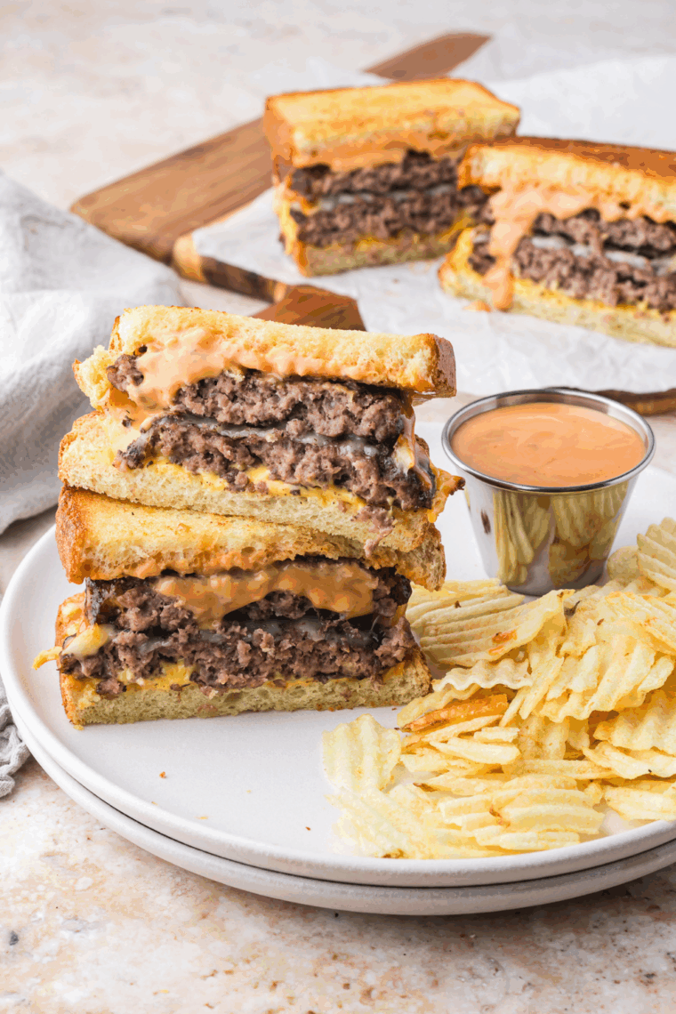 Plate of Hardee's Frisco Burger Recipe with French fries on a plate.