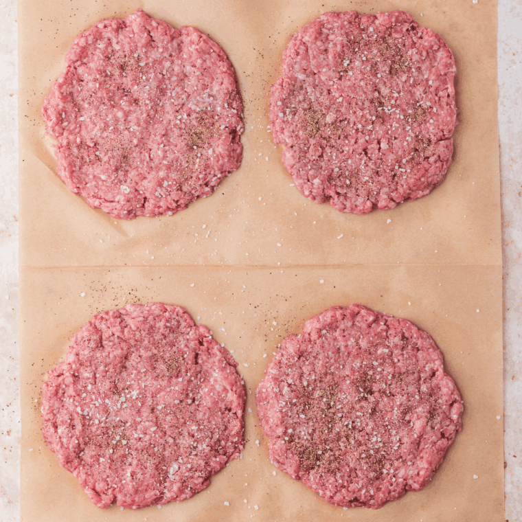Season the hamburger patties with salt and black pepper.