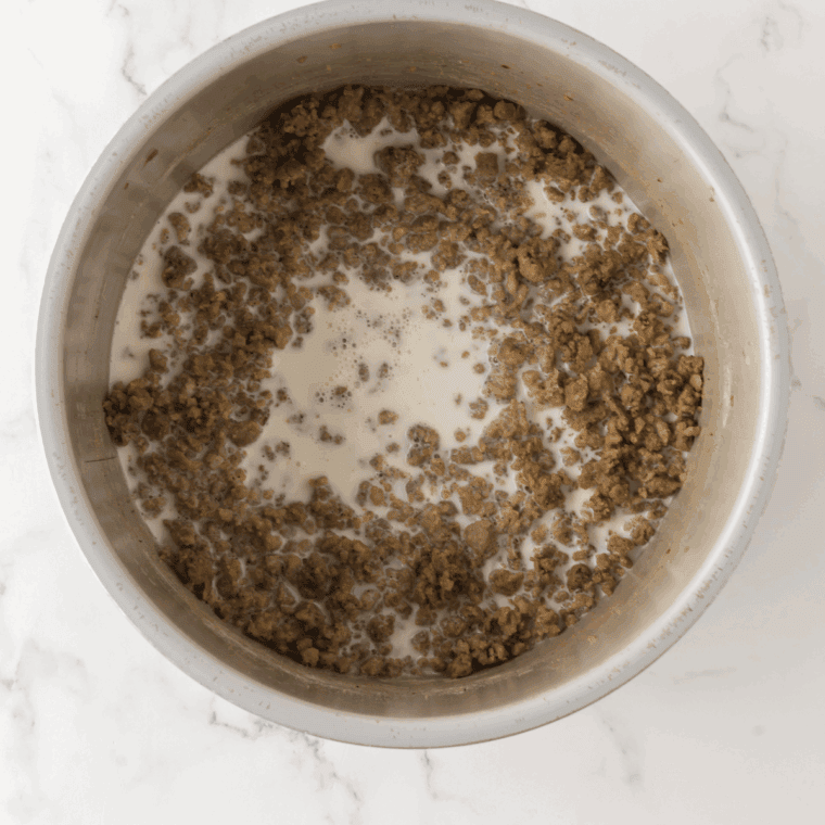 Brown the sausage gravy in a large skillet or pot.