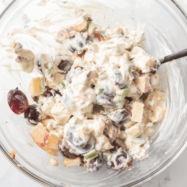 Toss Homemade Copycat Arby’s Chicken & Pecan Salad Recipe ingredients in a mixing bowl.