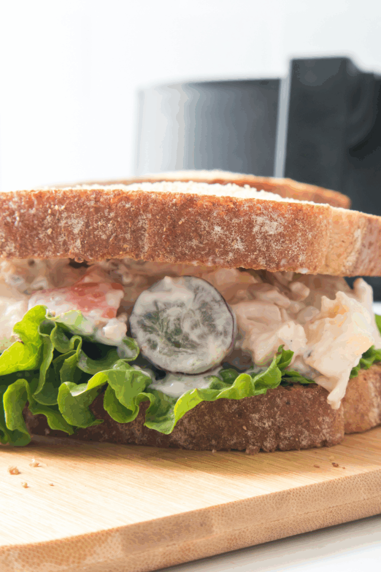 Bowl of creamy homemade Arby’s chicken salad with apples and pecans served on a croissant.