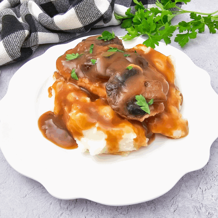 Rich buttery homemade KFC-style gravy poured over mashed potatoes.