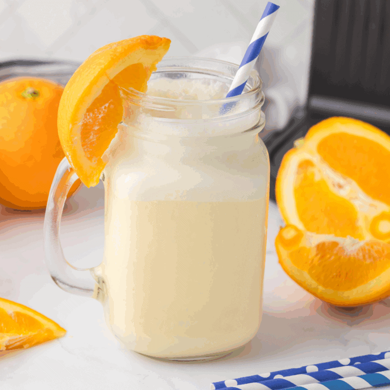 Creamy orange creamsicle shake made in Ninja Creami, topped with whipped cream.