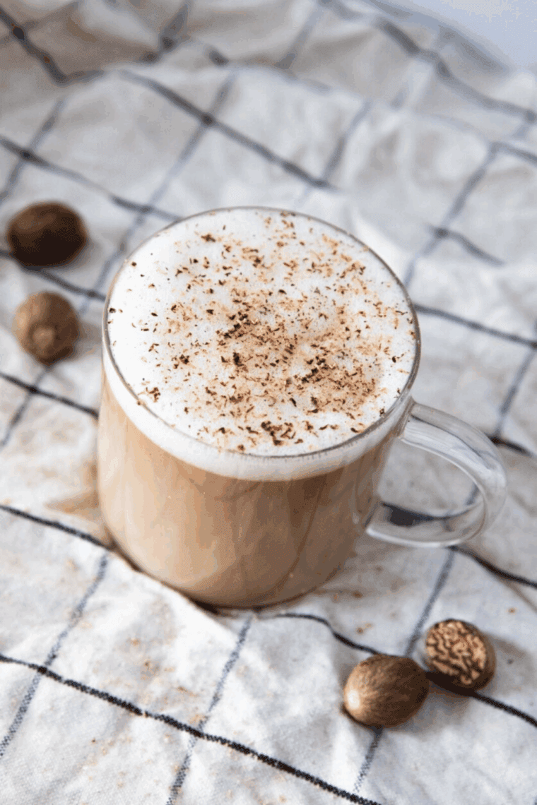 Glass of Ninja Creami McDonald’s copycat frappe topped with whipped cream and chocolate drizzle