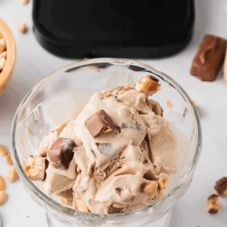 Bowl of Ninja Creami Dairy Queen Snickers Blizzard Copycat Recipe on kitchen table.
