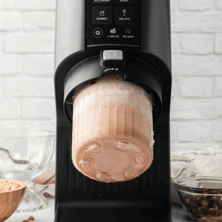 Ninja CREAMi machine running on Ice Cream mode with attached pint