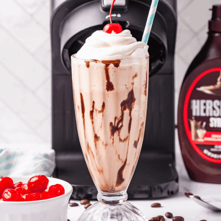 Homemade Ninja Creami Jamocha Shake in a glass with whipped cream and chocolate drizzle