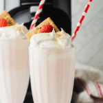 Homemade McDonald’s-style strawberry milkshake made in the Ninja Creami, served in a tall glass with whipped cream and a cherry on top.
