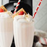 Homemade McDonald’s-style strawberry milkshake made in the Ninja Creami, served in a tall glass with whipped cream and a cherry on top.