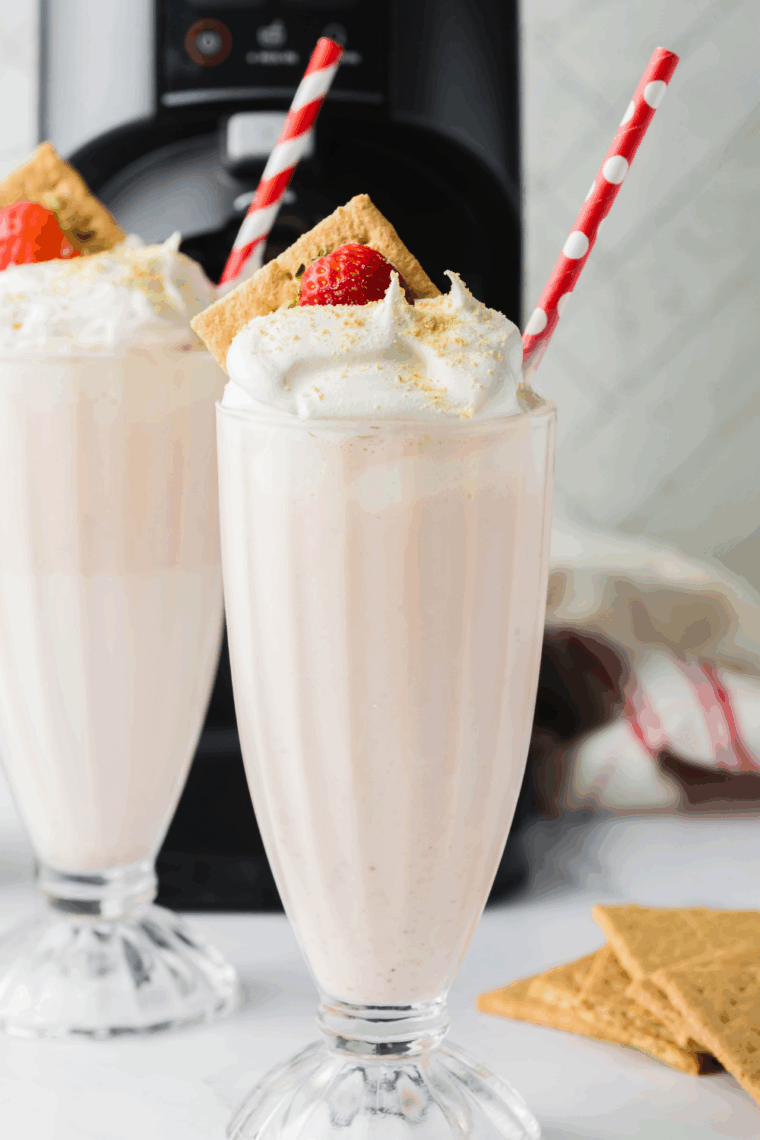 Homemade McDonald’s-style strawberry milkshake made in the Ninja Creami, served in a tall glass with whipped cream on top.