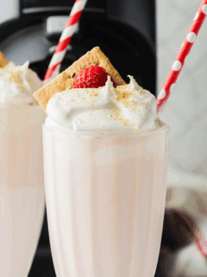 Homemade McDonald’s-style strawberry milkshake made in the Ninja Creami, served in a tall glass with whipped cream and a cherry on top.