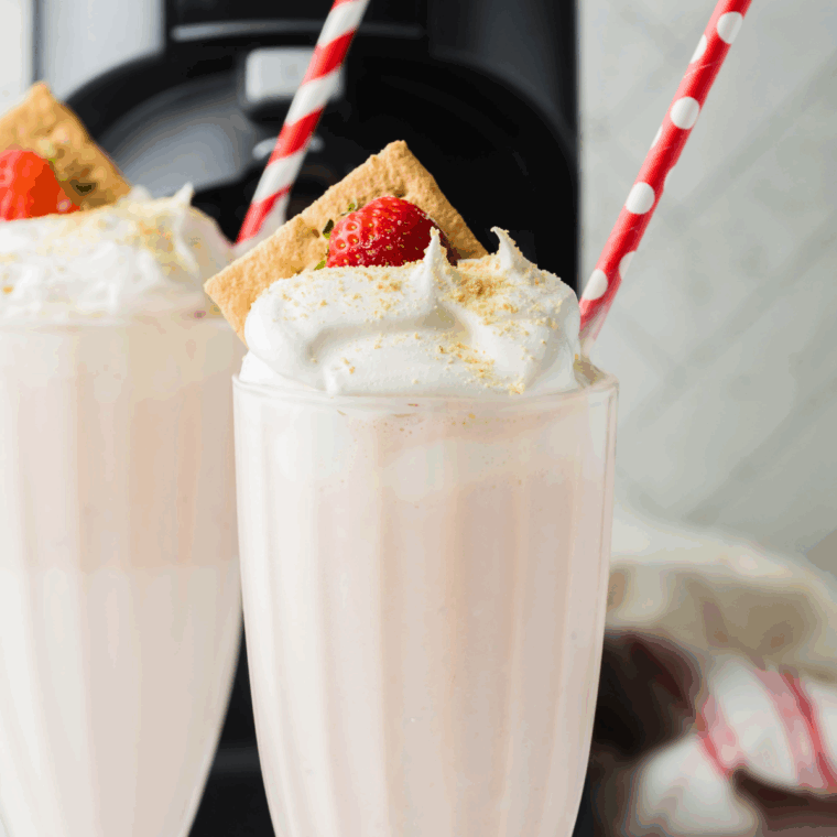 Homemade McDonald’s-style strawberry milkshake made in the Ninja Creami, served in a tall glass with whipped cream and a cherry on top.