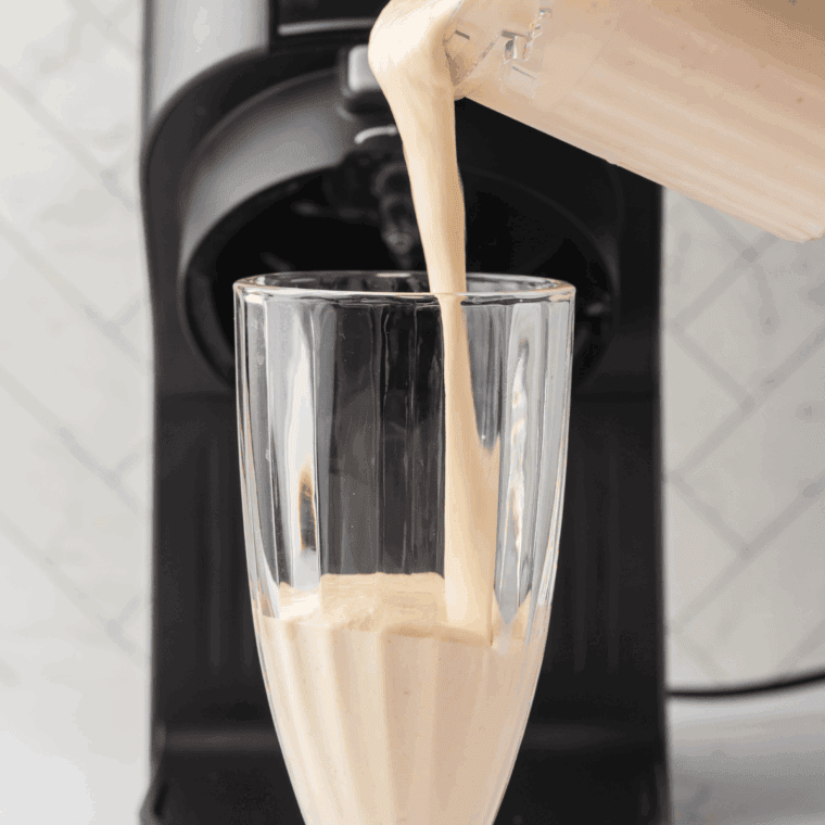 Pour McDonald's Vanilla Milkshake into a tall glass.