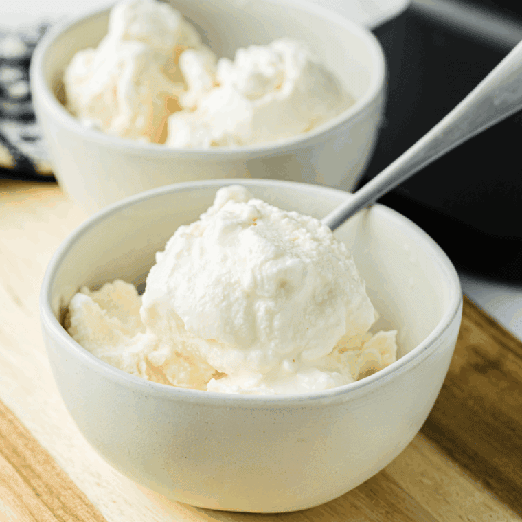 Bowl of creamy Ninja Creami vanilla almond ice cream topped with sliced almonds