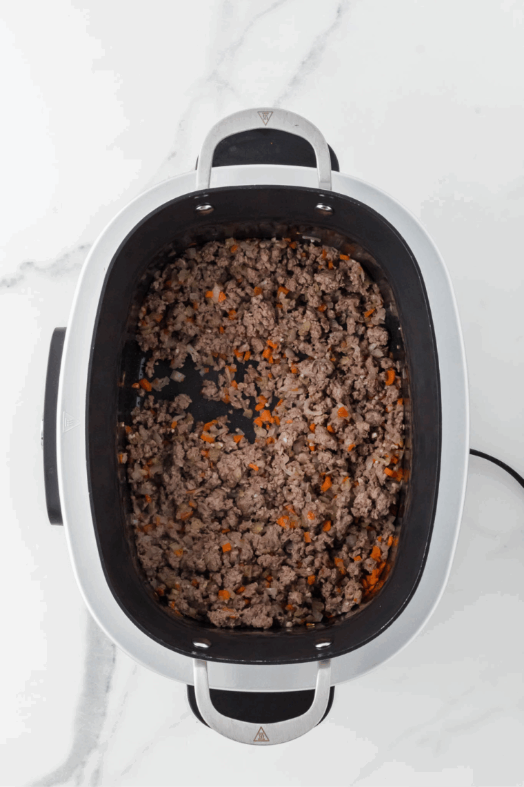 Brown beef in ninja food, separate it with a spoon.