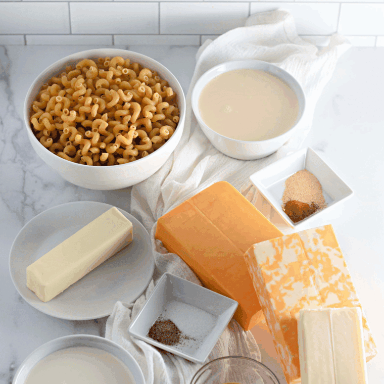 Ingredients needed for Old-Fashioned Baked Macaroni and Cheese on kitchen table.