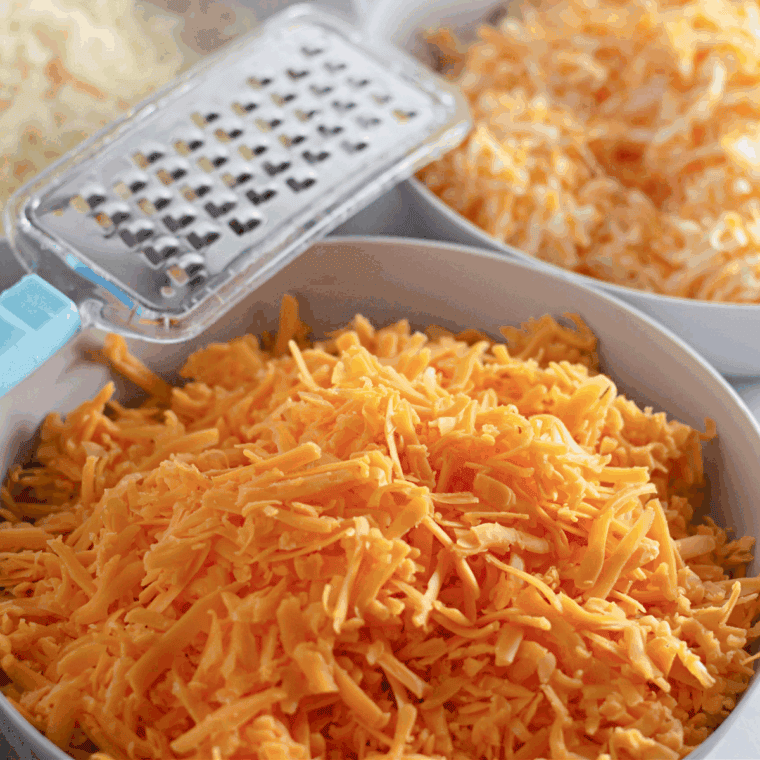 Shredding the fresh cheese for the macaroni and cheese.