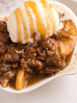 Bowl of cinnamon apple oblivion with ice cream, pecan crumble, and caramel sauce.