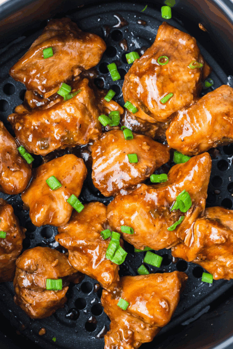 Grilled teriyaki chicken thighs glazed with teriyaki sauce served on a plate.