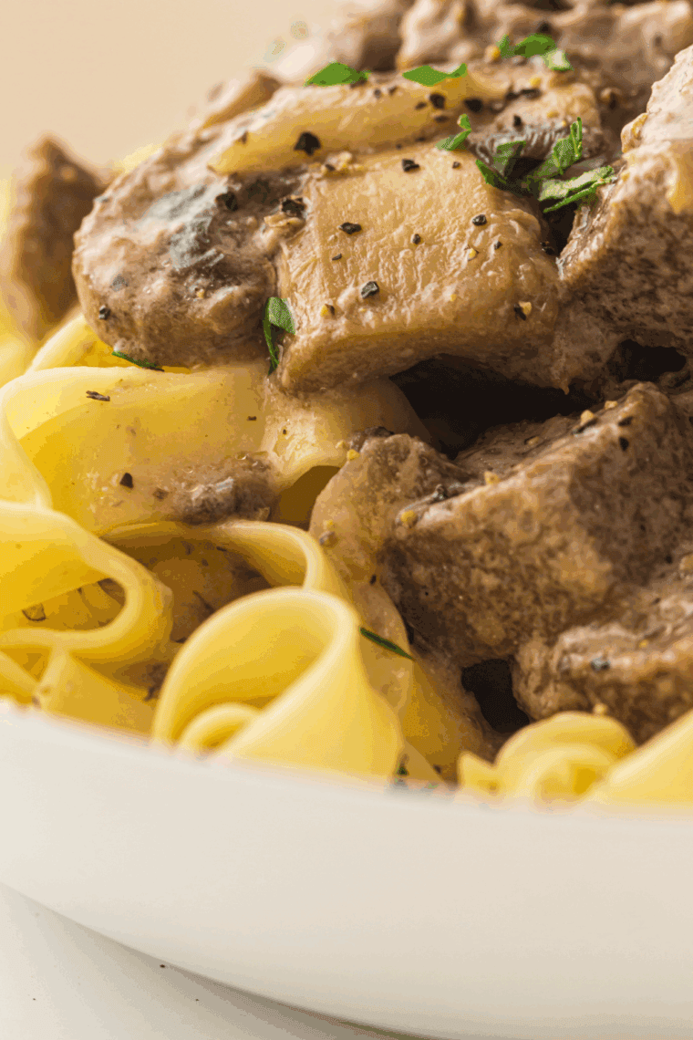 Creamy slow cooker beef stroganoff with tender beef and mushrooms over egg noodles.