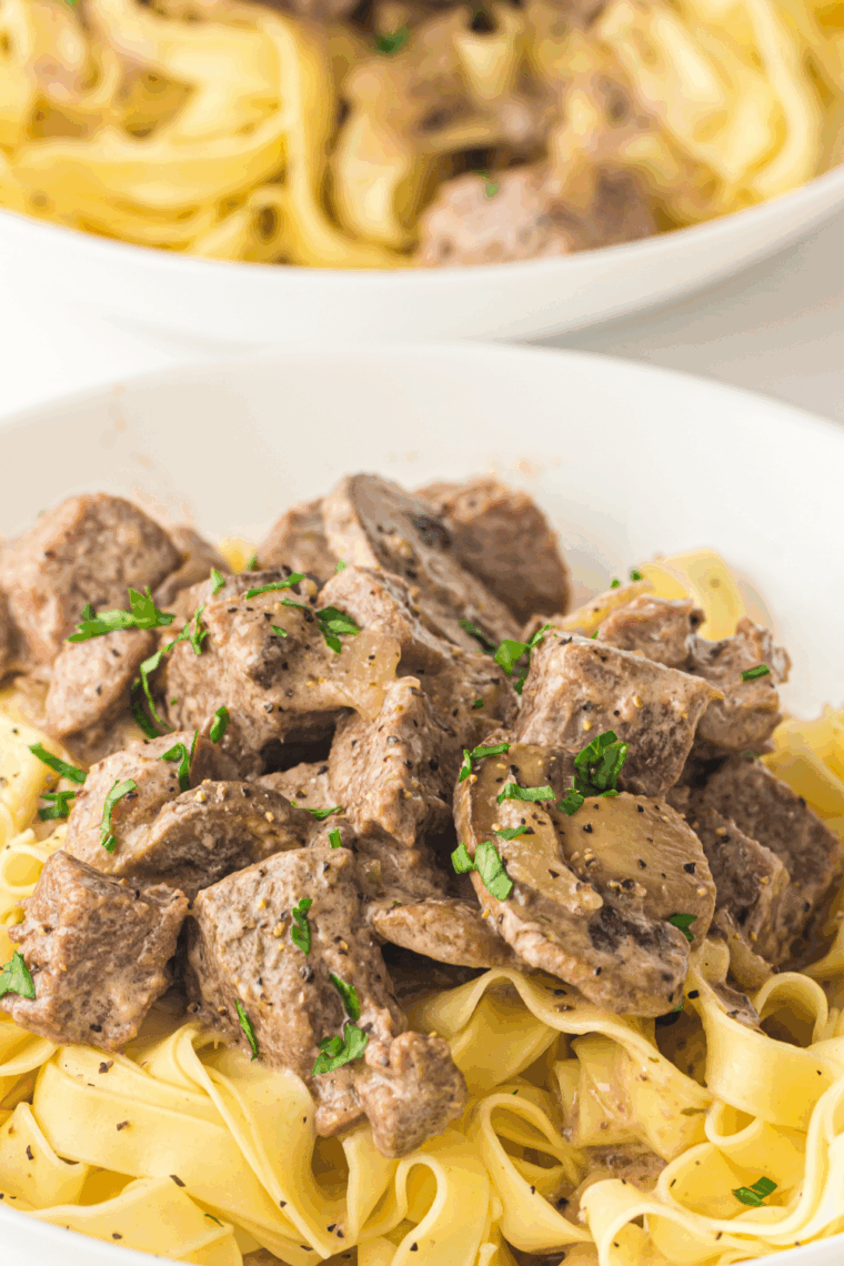 Plate of Slow Cooker Beef Stroganoff with fresh herbs on top.