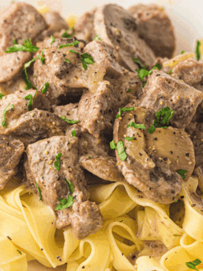 Slow Cooker Beef Stroganoff with tender beef, mushrooms, and creamy sauce served over egg noodles.