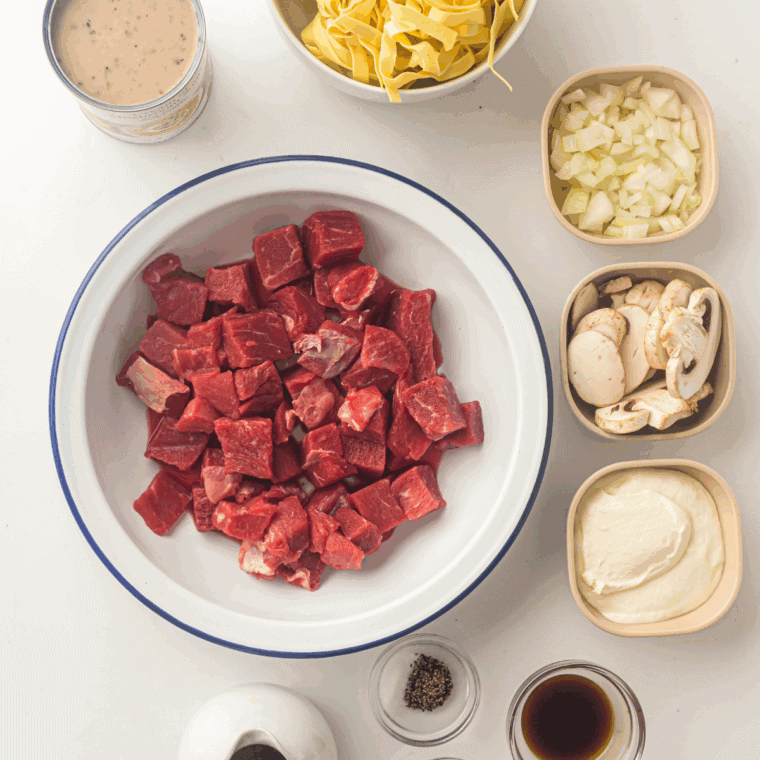 Ingredients needed for Slow Cooker Beef Stroganoff on kitchen table.