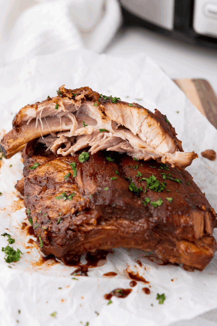 Slow cooker ribs coated with BBQ sauce and Dr. Pepper, cooked to tender perfection.