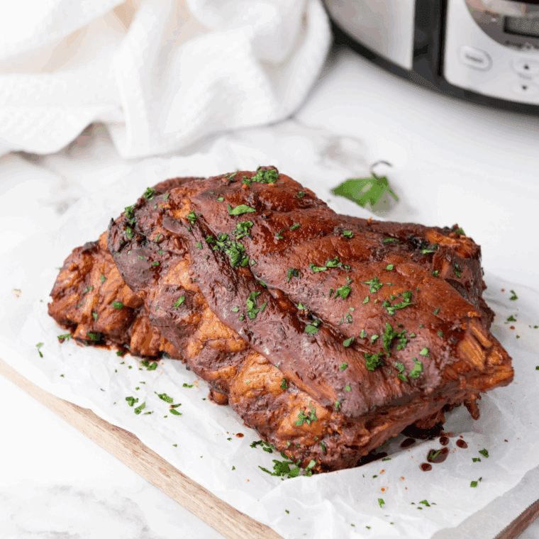 Slow-cooked ribs glazed with BBQ sauce and Dr. Pepper in a crockpot.