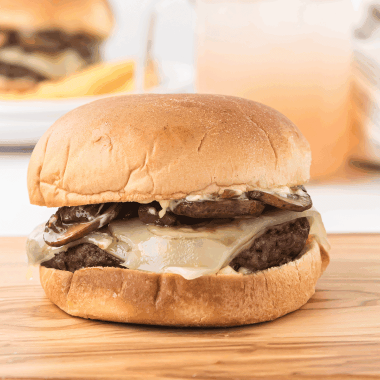 Plate of hamburger with Smashburger Smash Sauce on top.